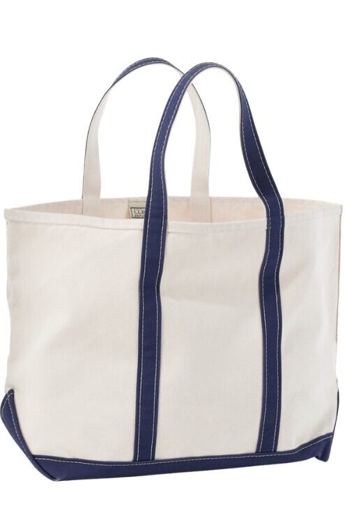 Beige canvas tote bag with navy blue handles and a dark blue bottom edge on a white background.