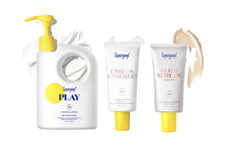 Set of Supergoop sunscreen products: a pump bottle labeled Play SPF 50 and two squeeze tubes (Unseen SPF 50, Glow Screen SPF 40) with swatches behind.
