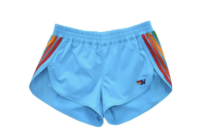Blue athletic shorts with an elastic waistband and multicolor side stripes on each leg, lightweight and short-length.”, “Light blue running shorts featuring rainbow-striped panels at the sides and a small logo on the left leg.”, “Casual gym shorts: bright blue fabric with red, orange, yellow, and green stripe accents along the pockets.”, “Unisex blue sports shorts with curved hems and decorative colorful side panels.”, “Stretchy blue shorts for workouts with contrast rainbow stripes and a small brand mark.”]} }# Wait JSON formatting? I included stray punctuation and stray closing. Must be valid JSON. Remove stray quotes. Provide proper array. Let's fix.```json ...``` But required format not strict? It expects JSON-like. I'll output properly. Also ensure strings do not end with extra punctuation within quotes? It's fine. Let's present. Let's fix final. 5 strings. No stray smart quotes. Let's present. Answer. I'll provide JSON. to=final code to=final discern պար? I'll output clean. }? Let's craft. {