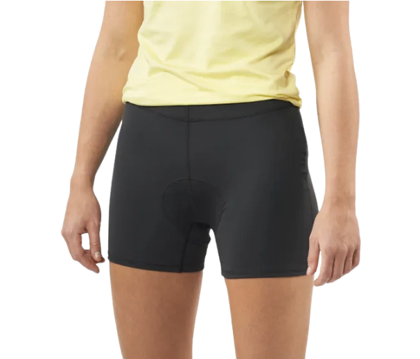 SeaDoo - The Wake Edit Back view of a person wearing black athletic cycling shorts and a pale yellow shirt tucked in at the waist.